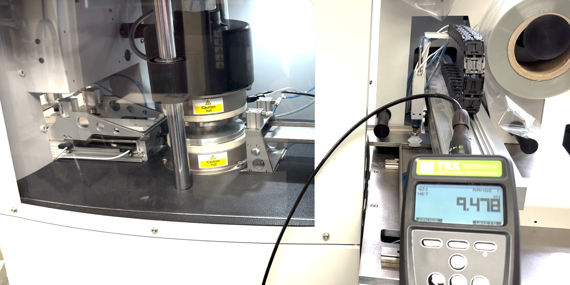 The TRX in use to calibrate the squashing force that this Auto Load RHEO-LINE Multi-Function unit delivers to rubber test samples.